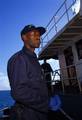 Midway Island, North Hawaiian Islands (Aug. 28) -- TC2 Maurice Frazier, CGC Jarvis (WHEC-723), stands a vigilant guard during the migrant offload at the atoll. On Aug. 24, boarding team members from the cutters Kukui (WLB-203) and Jarvis detained more than 75 undocumented Asian migrants aboard the converted coastal freighter north of the atoll. USCG photo by PA3 Sarah Foster-Snell (114080) ( COAST GUARD PEOPLE (FOR RELEASE )