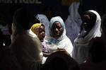 Girls participate in a Muslim prayer service that brought together Christian and Muslim women to honor the civilians killed in three months of post-election violence, following Friday prayers at a mosque in the Treichville neighborhood of Abidjan, Ivory Coast Friday, March 11, 2011. A day earlier, the women's group had attended a Catholic mass together. More than 400 people have been killed in violence, most of them supporters of the internationally recognized election winner Alassane Ouattara.