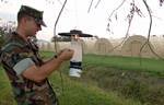 Forward Deployable Preventive Medicine Unit (FDPMU) East, removes a Light Trap provided by the Centers for Disease Control (CDC) from a tent city area on board NAS JRB New Orleans.