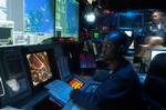 Operation Specialist 3rd Class Chiquica Sherman of Valdosta, Ga., monitors the air and surface status in the Combat Direction Center (CDC) aboard the conventionally powered aircraft carrier USS John F. Kennedy (CV 67).