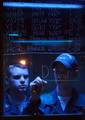 Operations Specialist 3rd Class Richard Taylor, left, and Operations Specialist Seaman Zachary Machnics, right, post updates in their workstation in the Combat Direction Center (CDC) on board USS Theodore Roosevelt (CVN 71).