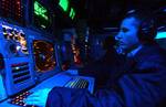 Operations Specialist 2nd Class Randy Proctor, of Melbourne, Fla., stands watch on the Global Command Control System (GCCS) in the Combat Direction Center (CDC).