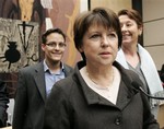 The newly elected leader of the French Socialist Party Martine Aubry arrives at a press conference, in Paris, Saturday, Nov. 22, 2008. Former Labor Minister Martine Aubry edged out 2007 presidential candidate Segolene Royal by 42 votes in a runoff in which nearly 135,000 members of France's main opposition party cast ballots, the party said. Others are unidentified.