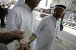 A Palestinian man exchanges currency, in the in city of Rafah the southern Gaza Strip, the U.S. dollar and shekel in black markets in the Gaza Strip on Sep. 20, 2011. Significant increase to the U.S. dollar $1000 against Israel 3.63. shekel in the Palestinian territories, the first time in five years, gets high for the dollar a due to protests in Israel, analysts said economy Palestinian. ( Photo by Ahmed Deeb/WN)