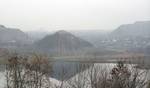 The slag heaps near the Kalmius. On a foreground - Chervonogvardejskij raion of Makiivka Donetsk lies in the steppe landscape of Ukraine, surrounded by scattered woodland, hills (slag heaps), rivers, and lakes.