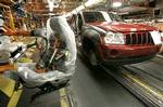 A seat manufactured by Johnson Controls awaits installation into a Jeep Grand Cherokee at the Chrysler Jefferson North assembly plant in Detroit, July 28, 2005. Johnson Controls Inc. said Monday, Oct. 24, 2005 its profit rose in the latest quarter on higher sales of industrial equipment. The Milwaukee-based maker of car parts and building climate-control systems that heat and cool buildings said net income for the fiscal 2005 fourth quarter ended Sept. 30 rose to $283.8 million, or $1.45 a share