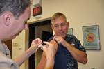 Capt. Bill Mosk, commander of U.S. Naval Activities Spain, receives the H1N1 Vaccine at U.S. Naval Hospital Rota, Spain.