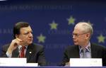 European Council President Herman Van Rompuy, right, shares a word with European Commission President Jose Manuel Barroso during a media conference after an EU summit in Brussels, Thursday, Feb. 11, 2010. Germany and France dangled a limited promise of 