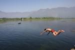 Kashmiri boys jump into Dal Lake to beat the heat Srinagar on 16, May 2011. The temperatures raise up to 29 degree Celsius.