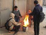 School boys warm themselves on a cold morning in Srinagar on December 26, 2010. Jammu and Kashmir is reeling under intense cold weather conditions with night temperatures dipping to minus 5.4 degrees Celsius ( 22.28 degrees Fahrenheit).