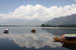 Shikaras (boats) are rowed across famous Dal Lake in Srinagar, the summer capital of Indian Kashmir, under thick clouds, on 02 June 2011. India's National Centre for Medium Range Weather Forecasting (NCMRWF) on 01 June predicted partly cloudy partly sunny weather with some temporary rains for the upcoming days with temperatures rising to up to 35 degrees Celsius (95 degrees Fahrenheit for the Srinagar region.