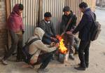 School boys warm themselves on a cold morning in Srinagar on December 26, 2010. Jammu and Kashmir is reeling under intense cold weather conditions with night temperatures dipping to minus 5.4 degrees Celsius ( 22.28 degrees Fahrenheit).