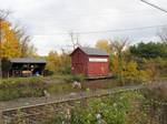 Buildings of the Windsor Locks Canal company alongside the Enfield Falls Canal in Windsor Locks, Connecticut with Amtrak's New Haven-Springfield Line in the foreground.