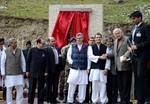 Rahul Gandhi (wearing black waist coat), a lawmaker and son of India's ruling Congress party chief Sonia Gandhi and Omar Abdullah (wearing blue waist coat), Kashmir's chief minister, pose for a picture after a foundation stone laying ceremony for a tunnel on the Srinagar-Leh highway in Sonamarg, 89km (55 miles) east of Srinagar, October 4, 2012. A foundation stone laying ceremony for a tunnel on 443 km (275 miles) long highway connecting Kashmir with the Buddhist-dominated Ladakh region was held