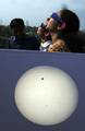 A projected image from a telescope of Planet Venus in transit across the Sun is pictured on a screen as skygazers watch the celestial event using protective eyewear in Kolkata on June 6, 2012. Astronomers around the world trained their telescopes on the skies to watch Venus pass in front of the Sun, a once-in-a-lifetime event that will not be seen for another 105 years