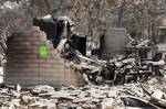 The charred remains of a home is all that is left of a child care business in Bastrop County, Texas, after a fire swept through the area, 13 September, 2011.