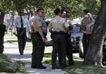 Los Angeles County sheriff's deputies stand down the street from a suburban Los Angeles home believed to be that of filmmaker Nakoula Basseley Nakoula, Friday, Sept. 14, 2012.