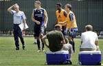 Chelsea owner Roman Abramovich, seated at right, and an unidentified man watch as, from left rear, coach Jose Mourinho and players Michael Ballack (13), John Obi Mikel and an unidentified player, as the two-time defending English Premiership champions Chelsea Football Club train at the University of California at Los Angeles Wednesday, Aug. 2, 2006. Chelsea FC will face a Major League Soccer all-star team in Chicago on Aug. 5.