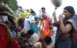 One of the Royal Family Member of Kolkata perform the ritualistic 'Nabapatrika Snan' - bathing a banana tree - in the Ganges river, in Kolkata, 21 October 2012. The four day long festival of Durga Puja, which began on 19 October this year, will culminate with the immersion of the clay idol of the Hindu Goddess Durga, which symbolises the power and the triumph of good over evil in Hindu mythology