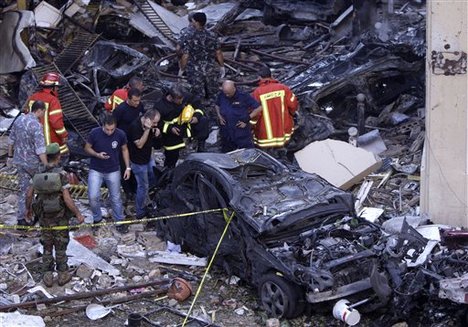 Lebanese soldiers and rescue workers inspect damage from an explosion in the mostly Christian neighborhood of Achrafiyeh, Beirut, Lebanon, Friday Oct. 19, 2012.