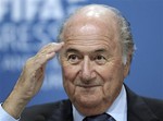 FILE - In this Wednesday, June 1, 2011 file photo Swiss FIFA President Sepp Blatter reacts during a press conference after the 61st FIFA Congress in Zurich, Switzerland. Sepp Blatter said Friday Nov. 18, 2011 he is "sorry' for offending anyone by his comments on racism in football but will not resign as FIFA president. Blatter told the BBC in an interview in Zurich that he "deeply regretted" using "unfortunate words" earlier this week, when he said any racist abuse on the football field could be settled by a handshake at the end of the match.