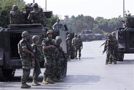 Lebanese Army soldiers deploy after overnight clashes between Sunni and Shiite gunmen in Beirut, Lebanon, Monday, Oct. 22, 2012.