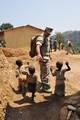 Hospital Corpsman 2nd Class Porfirio Nino, assigned to Maritime Civil Affairs Team (MCAT) 104, plays with local children from the Bunyamanza village