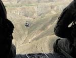 U.S. Army Staff Sgt. Nicholas Sheffield and Sgt. Randy Robertson keep a watchful eye from the back of a CH-47 Chinook helicopter while transporting commandos and special operations forces to the Afghan National Army's 203rd Thunder Corps in the Khost province of Afghanistan April 28, 2010.