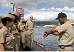 Chief of the Boat (COB), Master Chief Sonar Technician Mark Lemon, explains to the Druid Hills Naval Junior Reserve Officers Training Corps (NJROTC) how a submarine submerges.