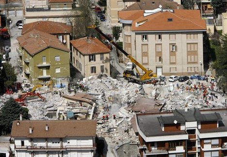 An aerial view of rescue operations in L'Aquila, a day after a powerful earthquake struck the Abruzzo region in central Italy, on Tuesday, April 7, 2009. The death toll from Italy's worst earthquake in three decades jumped to 207 as bodies were recovered and identified. Fifteen people remained unaccounted fo