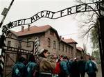 In this file photo of Wednesday April 22, 1998, young Israelis walk under the sign at Auschwitz concentration camp reading 