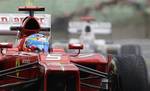 Spain's Ferrari driver Fernando Alonso steers his car through the rain during the second training session at the Hungaroring circuit outside Budapest, Hungary