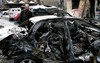 A Syrian man looks at a damaged car at the site after a car bomb attack in Bab Touma neighborhood, a popular shopping district largely inhabited by Syria's Christian minority in Damascus, Syria, Sunday, Oct. 21, 2012.