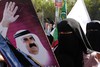 Palestinians holds the Qatari flag and pictures of the Emir of Qatar Sheik Hamad bin Khalifa al-Thani near the Rafah border crossing with Egypt prior to the arrival of Qatari Emir Sheikh Hamad bin Khalifa al-Thani to the Gaza Strip on October 23, 2012. The Emir of Qatar entered the Gaza Strip for a visit that will raise the prestige of its isolated Islamist rulers in the Hamas movement, but disappoint Israel and mainstream Palestinian leaders in the West Bank.