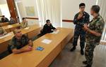 Lt. Kent Bubel speaks with a maritime search and rescue workshop instructor at the Armed Forces of Malta Maritime Safety and Security Training Center during Eurasia Partnership Capstone 2011.