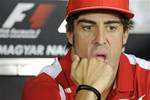 Ferrari driver, Spain's Fernando Alonso gestures during a press conference at the Hungaroring circuit outside Budapest, Hungary