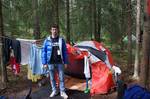 In this Friday July 20, 2012 photo Cristian Tudose, 31, from Romania, stands outside his tent in a Norwegian forest at Lake Sognsvann, near Oslo, Norway. Tudose came here to look for work during his country's financial crisis, and now sells magazines on the streets of Oslo.