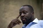 Haiti's presidential candidate and hip hop singer Wyclef Jean, speaks during an interview with The Associated Press at his mother's house in Croix de Bouquets, Haiti, Wednesday, Aug. 18, 2010.