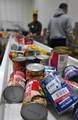 BALTIMORE - Donated canned goods roll down a conveyer belt to be sorted by volunteers from the Coast Guard at the Maryland Food Bank in Halethorpe, Md., Feb. 2, 2011. The volunteers packed more than 34,000 pounds of food that will be distributed to Maryland families living under the poverty line. U.S. Coast Guard photo by Petty Officer 3rd Class Robert Brazzell. (1106670) ( Volunteers assist food bank )