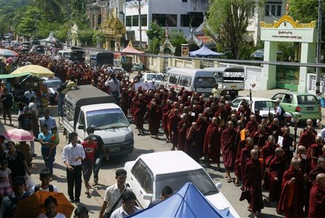 Myanmar Buddhist monks march, protesting against plans to open office of the Organization of the Islamic Conference (OIC), in Yangon, Myanmar, Monday, Oct. 15, 2012.