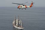 BOSTON A MH-60T Jayhawk helicopter from Coast Guard Air Station Cape Cod in Buzzards Bay, Mass., flies over Coast Guard Cutter Eagle off the coast of Martha's Vineyard, Mass., July 28, 2011. The Eagle is underway on the 2011 Summer Training Cruise, which commemorates the 75th anniversary of the 295-foot barque. U.S. Coast Guard photo by Petty Officer 3rd Class Ann Marie Gorden. (1335613) ( 20110728 G 7444G_132 Formation Flight )