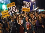 Protestors hold banners reading no financial cuts" and "crisis is a fraud" against austerity measures announced by the Spanish government in Madrid, Spain, Saturday, Oct. 13, 2012.