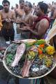 Devotee performs traditional ritual 'Tarpan' at the river of Ganga on the occasion of Sarva Pitri Amavasya to mark the end of Pitrupaksha in Kolkata on 15 October 2012. Pitru Paksha Shradh, or Pitr Paksh Shraddh, is the annual rites and rituals offered to ancestors, relatives and dead parents in the month of Ashwin in North India