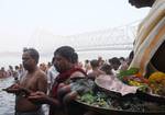 Devotee performs traditional ritual 'Tarpan' at the river of Ganga on the occasion of Sarva Pitri Amavasya to mark the end of Pitrupaksha in Kolkata on 15 October 2012. Pitru Paksha Shradh, or Pitr Paksh Shraddh, is the annual rites and rituals offered to ancestors, relatives and dead parents in the month of Ashwin in North India