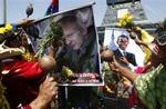 Shamans perform a ritual for good luck in 2011 as they hold up images of the founder of WikiLeaks Julian Assange, left, and President Barack Obama, right, in Lima, Peru, Wednesday, Dec. 29, 2010.