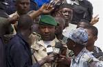 CORRECTS NAME AND POSITION - Lieutenant Amadou Konare, centre, spokesman for coup leader Amadou Haya Sanogo, unseen, addresses Sanogo supporters, as thousands rallied in a show of support for the recent military coup, in Bamako, Mali Wednesday, March 28, 2012.