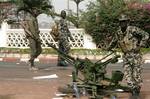 Soldiers stand guard outside the presidential palace after a military coup in Bamako, Mali, Friday March 23, 2012. The whereabouts of Mali's president Amadou Toumani Toure were unknown Friday, a day after mutinous soldiers declared a coup, raising fears and prompting uncertainty in a West African nation that had been one of the region's few established democracies.