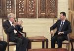 In this photo released by the Syrian official news agency SANA, Syrian President Bashar Assad, right, meets with the U.N.-Arab League envoy Lakhdar Brahimi, left, in Damascus, Syria, Saturday, Sept. 15, 2012. The new international envoy tasked with ending Syria's civil war says the country's conflict is a threat to world peace.