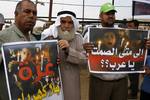 Palestinians hold slogans which read in Arabic 