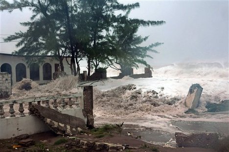 Waves, brought by Hurricane Sandy, crash on a house in the Caribbean Terrace neighborhood in eastern Kingston, Jamaica, Wednesday, Oct. 24, 2012.